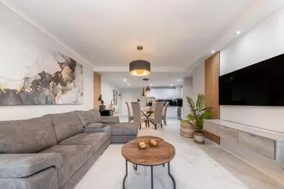 a living room with a couch and a table at Beautiful 3 bed apartment with sea views Horizon Bay 502 in Cape Town