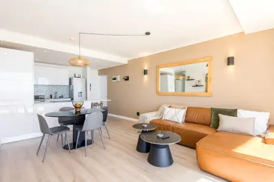 a living room with a couch and a table at Horizon Haven with stunning view by HMH 803 in Cape Town