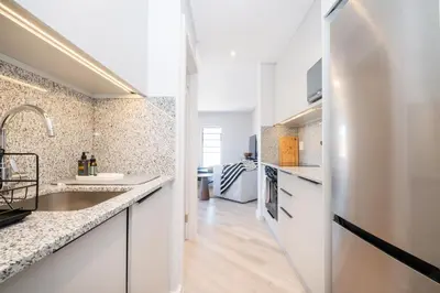a kitchen with a sink and a refrigerator at 221 Paarl Lux 1 Bdrm Apt with Mountain Views in Paarl