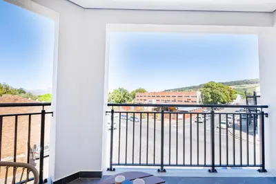 a balcony with a view of a city at 221 Paarl Lux 1 Bdrm Apt with Mountain Views in Paarl