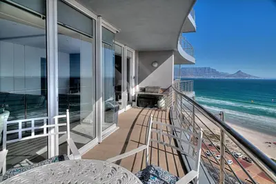 a balcony of a house with a view of the beach at Horizon Bay 1302 Loadshedding Free APT by HMH in Cape Town