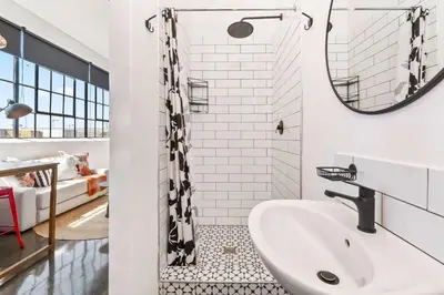 a bathroom with a sink and a mirror at Trendy Salt River Loft Apartment in Cape Town