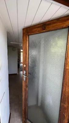 a glass door in a room with a hallway at Homey Central Apartment By ARPA in Stellenbosch