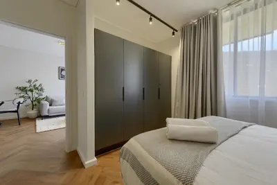 a bedroom with a bed and a large window at Luxe On Park Century City in Cape Town