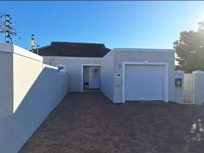 a white house with a garage and a driveway at Chelmsford Close Pinehurst - Excellent location! in Oakdale