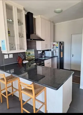 a kitchen with a counter and two stools in it at Chelmsford Close Pinehurst - Excellent location! in Oakdale