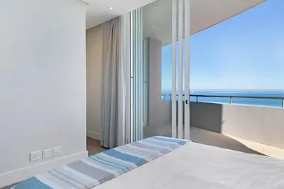 a bedroom with a bed with a view of the ocean at Horizon Bay 1602 Penthouse APT with lovely views in Cape Town