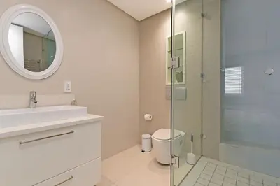 a bathroom with a shower and a sink and a mirror at Horizon Bay 1602 Penthouse APT with lovely views in Cape Town