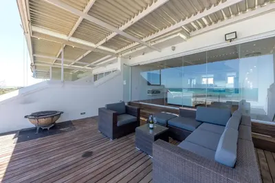 a living room with a couch and a table at Spinnakers 9 by HMH in Cape Town