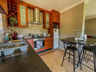 a kitchen with a sink and a counter top at Spacious mountain-view haven in Stellenbosch