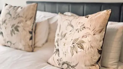 two pillows sitting on top of a bed at 2 Bedroom, 4 Sleeper Hidden Gem Minutes from Blouberg Beach Front in Cape Town