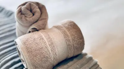 a rolled up towel sitting on top of a bed at 2 Bedroom, 4 Sleeper Hidden Gem Minutes from Blouberg Beach Front in Cape Town