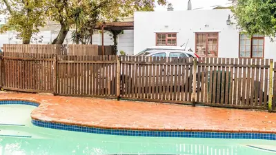 a wooden fence next to a swimming pool at Campbell's Corner in Cape Town