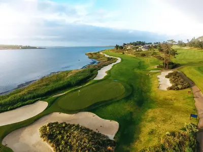 an aerial view of a golf course next to the ocean at Arabella Hotel, Golf and Spa in Kleinmond
