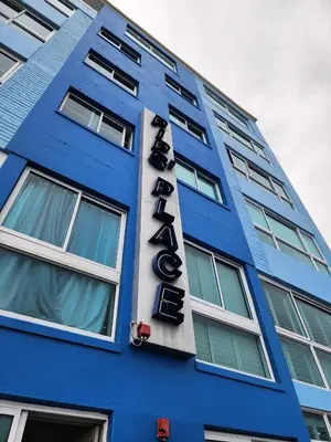 a blue building with a sign for a hotel at Seaview Serenity Strand in Strand