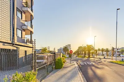 a street with a building and a stop sign at Contemporary Modern 1 Bedroom-19B, Blouberg in Cape Town