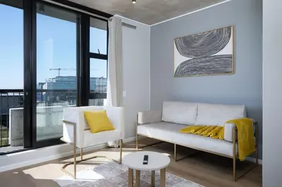 a living room with a couch and a chair at Riverlands Luxury Apartments by City Club in Cape Town
