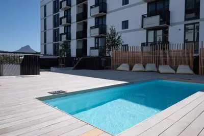 a swimming pool in front of a building at Riverlands Luxury Apartments by City Club in Cape Town
