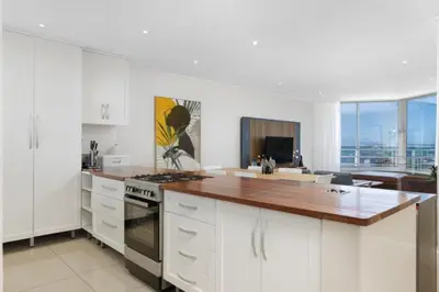 a kitchen with white cabinets and a counter top at Ashley On Beach 1104 Prestige Style in Strand