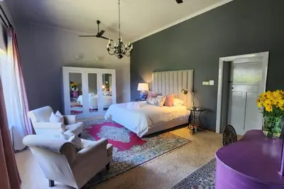 a bedroom with a bed and a couch and a chair at PicardiPlace in Rawsonville