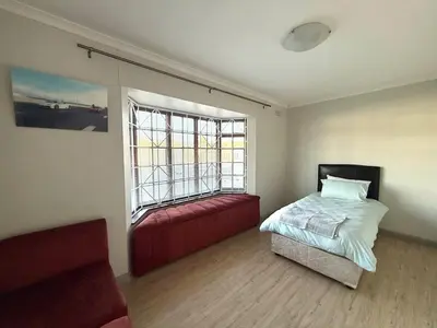 a bedroom with a bed and a large window at Spacious 3 Bedroom 2 Bathroom 6 Sleeper in Southfield