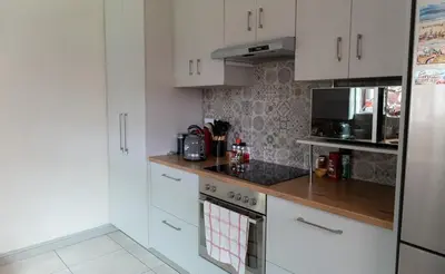 a kitchen with white cabinets and a stove top oven at Spacious 3 Bedroom 2 Bathroom 6 Sleeper in Southfield