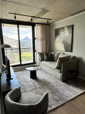 a living room with a couch and a table at Riverlands 2Bedroom Apartment with Mountain Views in Cape Town
