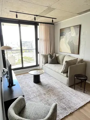 a living room with a couch and a table at Riverlands 2Bedroom Apartment with Mountain Views in Cape Town