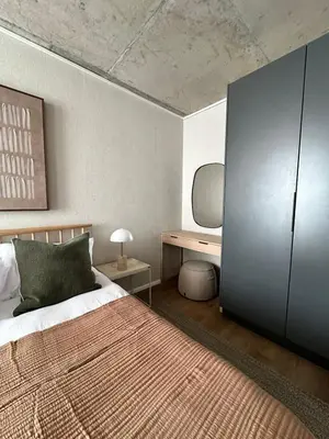 a bedroom with a large bed and a desk at Riverlands 2Bedroom Apartment with Mountain Views in Cape Town