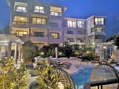 a large apartment building with a swimming pool at Misty Waves Boutique Hotel in Hermanus