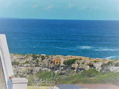 a view of the ocean from a house at Misty Waves Boutique Hotel in Hermanus