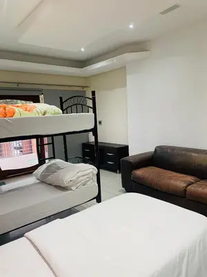 a living room with two bunk beds and a couch at Plattekloof Queens Guest House in Welgelegen
