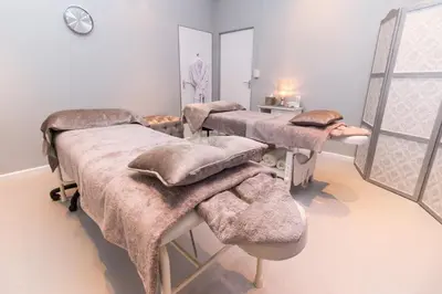 a hospital room with three beds and a mirror at The Marine Hermanus in Hermanus