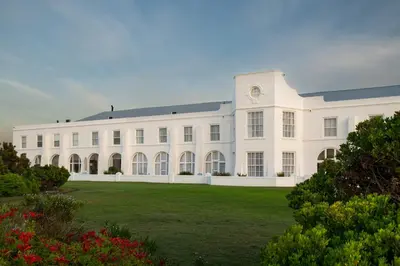 a large white building with a large yard at The Marine Hermanus in Hermanus