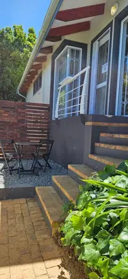 a house with a bench and stairs in front of it at Fair View in Somerset West