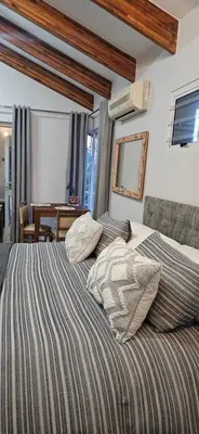 a bedroom with a bed with two pillows on it at Fair View in Somerset West