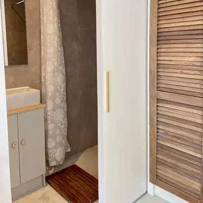 a bathroom with a sink and a shower at Spekboom in West Beach in Cape Town