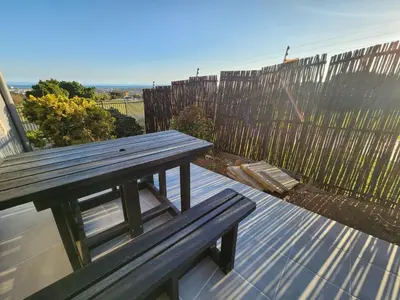 a wooden bench sitting on top of a roof at Units on 8Wingerd in Somerset West