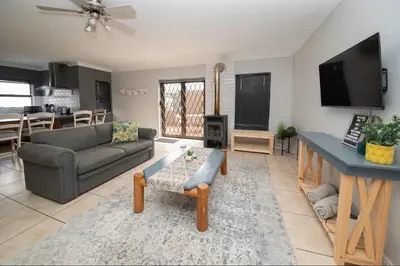a living room with a couch and a table at Units on 8Wingerd in Somerset West