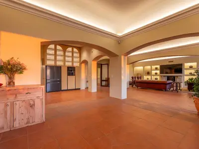 an open living room with a tile floor at Luxury beachfront villa Cape Town - Sunset Beach in Cape Town