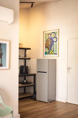 a kitchen with a refrigerator and a picture on the wall at Waterfront Studios - Hermanus Waterfront Apartments in Hermanus