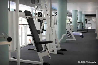 a gym with rows of treadmills and ellipticals at Majorca Apartments by BON Hotels in Cape Town
