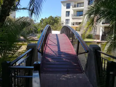a bridge over a river with a building in the background at Majorca Apartments by BON Hotels in Cape Town