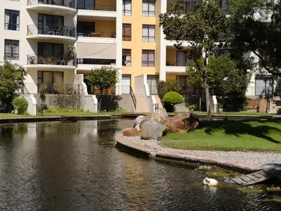 a building and a river in front of a building at Majorca Apartments by BON Hotels in Cape Town