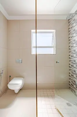 a bathroom with a toilet and a window at Cassamo house in Cape Town