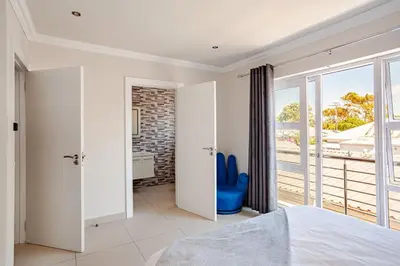 a bedroom with a bed and a large window at Cassamo house in Cape Town