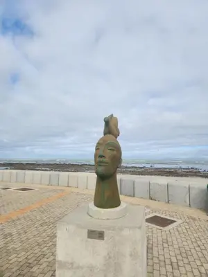 a statue of a head with a dog on top of it at Strand Beach House in Strand