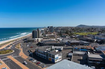 an aerial view of a city and the ocean at Stylish 2-Bedroom Sea-View Apartment Horizon Bay Blouberg Beachfront in Cape Town