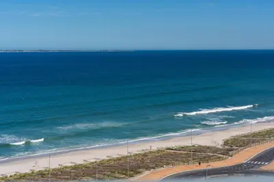 an aerial view of a beach and the ocean at Stylish 2-Bedroom Sea-View Apartment Horizon Bay Blouberg Beachfront in Cape Town