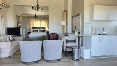 a kitchen and a living room with a bed and a couch at Dream Views in Somerset West